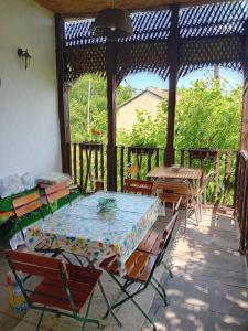 a patio with a table and chairs on a porch at Country house pivnica Milic Rogljevo in Rogljevo