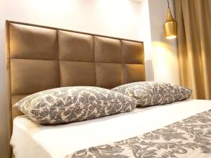 - deux oreillers installés sur un lit avec une tête de lit dans l'établissement Helle Ferienwohnung mit Meerblick vom privaten Sonnenbalkon - b57594, à Trogir