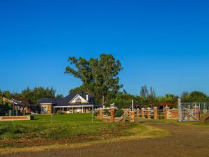 a house with a playground in front of it at Retief Guest Farm in Kroonstad
