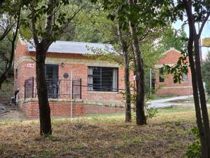 a brick building with a window in a yard at Retief Guest Farm in Kroonstad