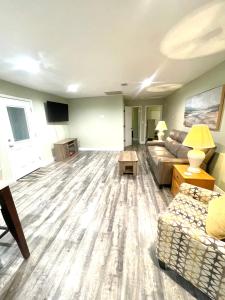 a living room with a couch and a tv at Ocean Springs Cottage 2 Bedroom 2 Bath in Ocean Springs