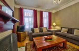 a living room with a couch and a coffee table at Les Maisons Montcalm in Quebec City