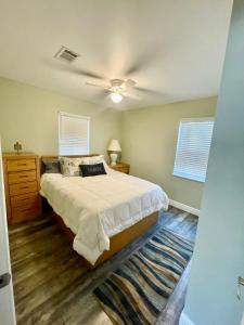 a bedroom with a bed and a ceiling fan at Ocean Springs Cottage 2 Bedroom 2 Bath in Ocean Springs +12 photos