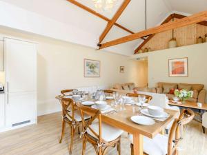 a dining room with a wooden table and chairs at 3 Bed in Blandford Forum 83014 in Woolland