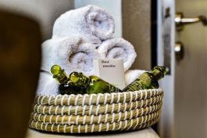 a basket filled with wine bottles and towels at DP Homes Santorini in Perissa +46 photos