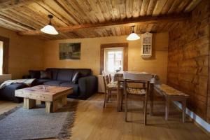 a living room with a couch and a table at Ferienwohnung in Klingenthal mit Terrasse, Grill und Garten in Klingenthal