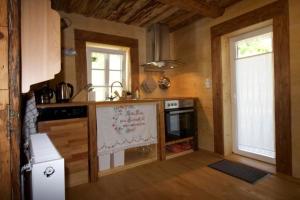 a kitchen with a stove and a counter top at Ferienwohnung in Klingenthal mit Terrasse, Grill und Garten in Klingenthal +9 photos