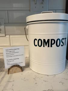 a bucket of compost sitting on a counter with a sign at Firefly Hills in Beattyville +33 photos