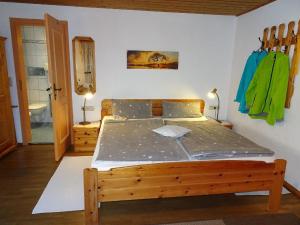 a bedroom with a wooden bed in a room at Bäriger Urlaub mit viel Herz in Bad Bayersoien