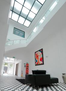 a living room with a couch and a skylight at Hotel Sky Blue in Manizales