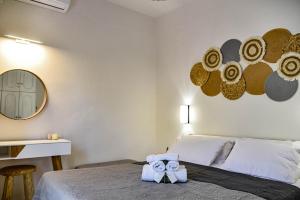 a bedroom with a bed with two towels on it at DP Homes Beachside in Santorini in Perissa
