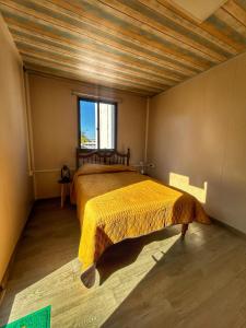 a bedroom with a large bed in a room at Yellow house 6 minutos de playa in Barra de Navidad