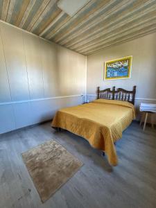 a bedroom with a large bed in a room at Yellow house 6 minutos de playa in Barra de Navidad +39 photos