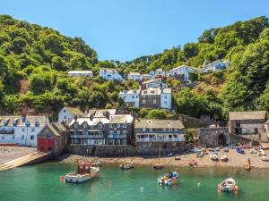a town on a hill with boats in the water at 2 bed in Clovelly 56720 in Woolfardisworthy