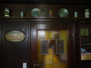 a wooden door with stained glass windows on it at Ferienhaus für vier Personen mit Sitzgelegenheit in Schöllnach