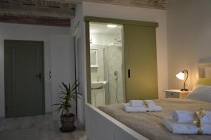 a bedroom with a large bed with two towels on it at NADIT Apartmanház in Hegykő +11 photos