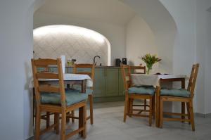 a kitchen with a table and two chairs and a counter at NADIT Apartmanház in Hegykő