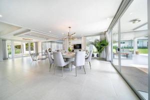 a dining room and living room with a table and chairs at Paradise Villa in La Romana