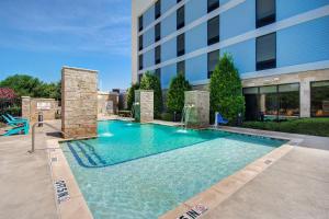 a large swimming pool in front of a building at Home2 Suites Dallas-Frisco in Frisco