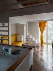 a living room with a yellow couch and stairs at Terra Mia in Piazza in Pompei