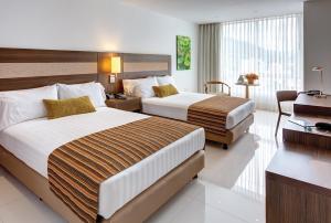 Ліжко або ліжка в номері Hotel Estelar Yopal