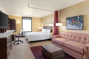 a hotel room with a bed and a couch at Home2 Suites by Hilton Salt Lake City/Layton in Layton