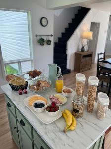 a breakfast table with breakfast foods and drinks on a counter at Gite - La ruée vers l'orge in Trois-Rivières