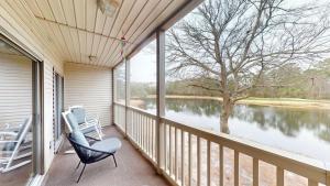 a porch with two chairs and a view of a lake at Two Bdrm Villa, True Blue, Golf Escape in Pawleys Island