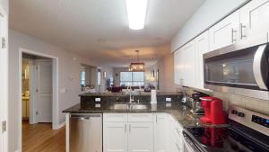 a kitchen with white cabinets and a counter top at Two Bdrm Villa, True Blue, Golf Escape in Pawleys Island