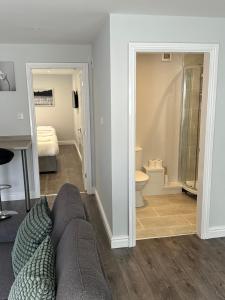 a living room with a couch and a bathroom at Smeaton street rooms in Liverpool