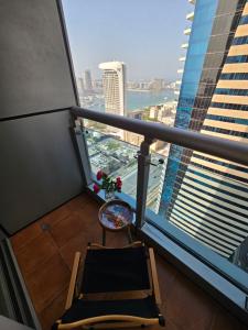 a balcony of a building with a chair and a window at Local Super Host Experience , Stylish Private Rooms in a Shared apartment in Dubai