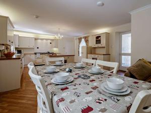 a kitchen and dining room with a table and chairs at 3 Bed in Biggar 82924 in Biggar