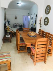 a dining room with a wooden table and chairs at Apartamento Carmen in Santa Cruz de Barahona