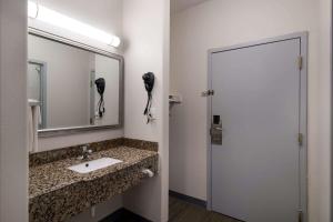 a bathroom with a sink and a mirror and a phone at Quality Inn Columbia I-65 in Columbia +18 photos
