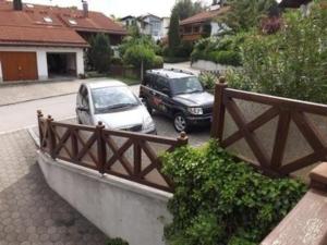 two cars are parked in a parking lot at Schönes Ferienhaus in Lechbruck Am See mit Großer Terrasse und Bergblick in Lechbruck