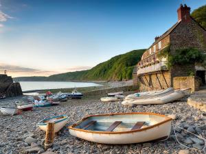 a group of boats sitting on a rocky beach at 1 bed property in Torrington 86890 in Shebbear