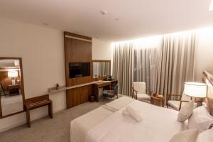 a hotel room with a bed and a desk at Wassad Hotel Makkah فندق وسد مكة in Makkah