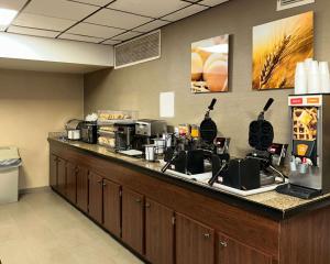 a kitchen with a counter with a coffee maker at Comfort Inn Falls Church - Tysons Corner in Falls Church