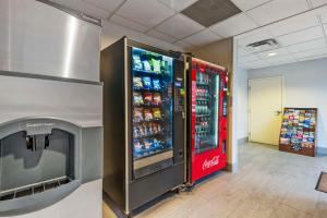 a soda vending machine in a room with a television at Comfort Inn Airport Turfway Road in Florence