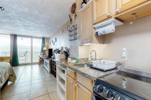 a kitchen with a sink and a counter top at Harbour Beach Resort Unit 808 in Daytona Beach