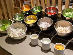 a group of bowls of food on a table at Comfort Hotel ERA Kobe Sannomiya in Kobe