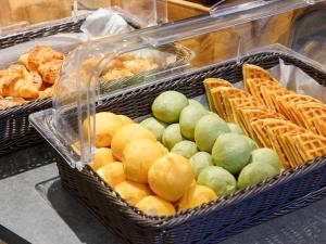 two baskets filled with lemons and bread and pastries at Comfort Hotel ERA Kobe Sannomiya in Kobe