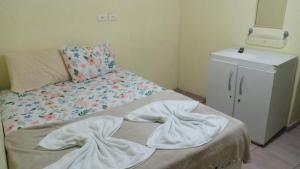 a room with a bed and a dresser at POUSADA LELÊ CONVENÇÕES in Recife