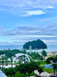 a view of a park with a white arch and the ocean at Pé na Areia em Santos in Santos +5 photos