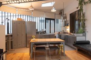 a kitchen with a table and chairs in a room at Lovely loft in the heart of Paris in Paris