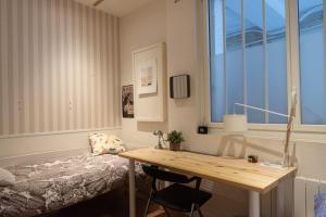 a bedroom with a desk and a bed and a window at Lovely loft in the heart of Paris in Paris