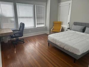 a bedroom with a bed and a desk and chairs at Luxury Stay in Montrose- Parma _ the Italian Plaza in Houston