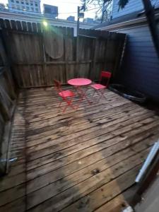 a picnic table and two chairs on a wooden deck at Luxury Stay in Montrose- Parma _ the Italian Plaza in Houston