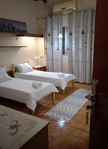 twee bedden in een kamer met gordijnen en een tapijt bij RESIDENCIA-UNIV in Ciudad del Este