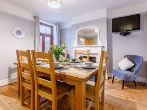 a dining room with a wooden table and chairs at 4 Bed in Bideford 85720 in Bideford